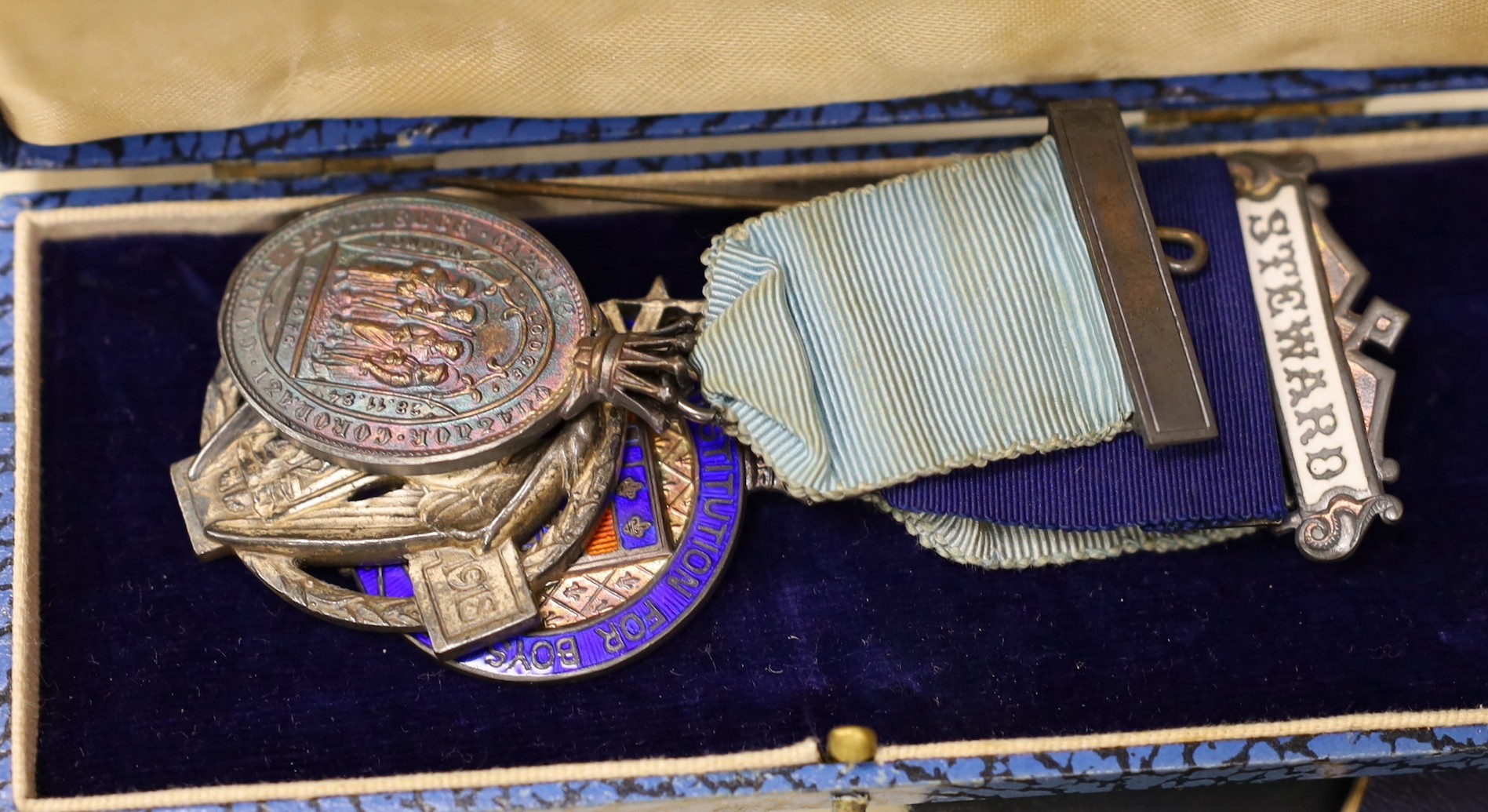 A collection of Masonic medals, cuffs and ephemera and, a W Masjid-1, Suleman Lodge Banquet menu autographed on the front cover and Proceedings of The Grand Lodge Bombay 1939, together in two suitcases